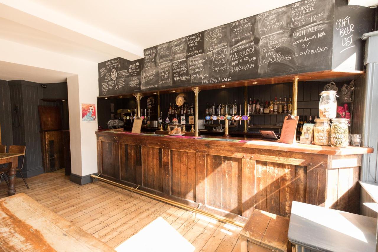 a restaurant with a bar with a chalkboard at The Black Fox in Bath