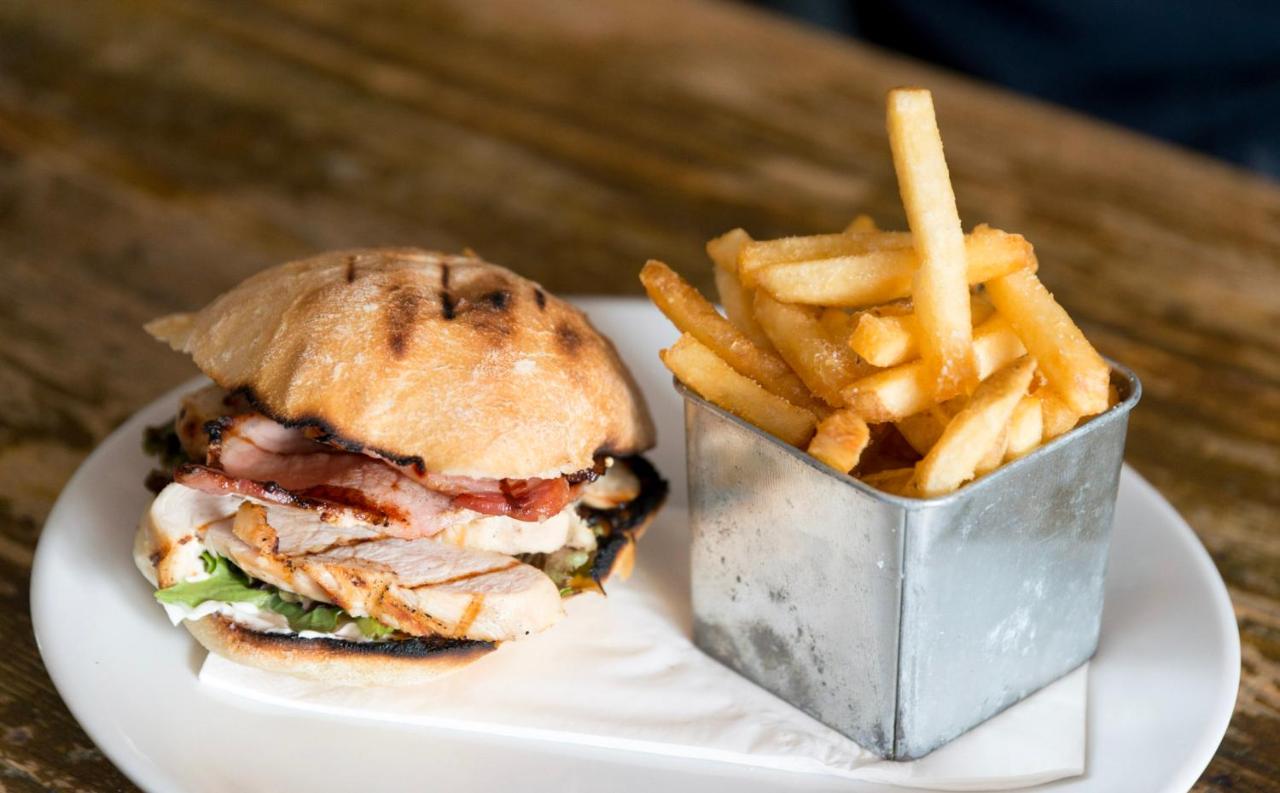 a sandwich and french fries on a white plate at The Black Fox in Bath