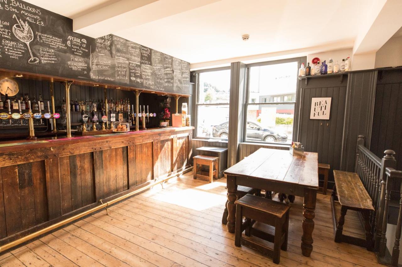 a restaurant with a wooden bar with a wooden table at The Black Fox in Bath