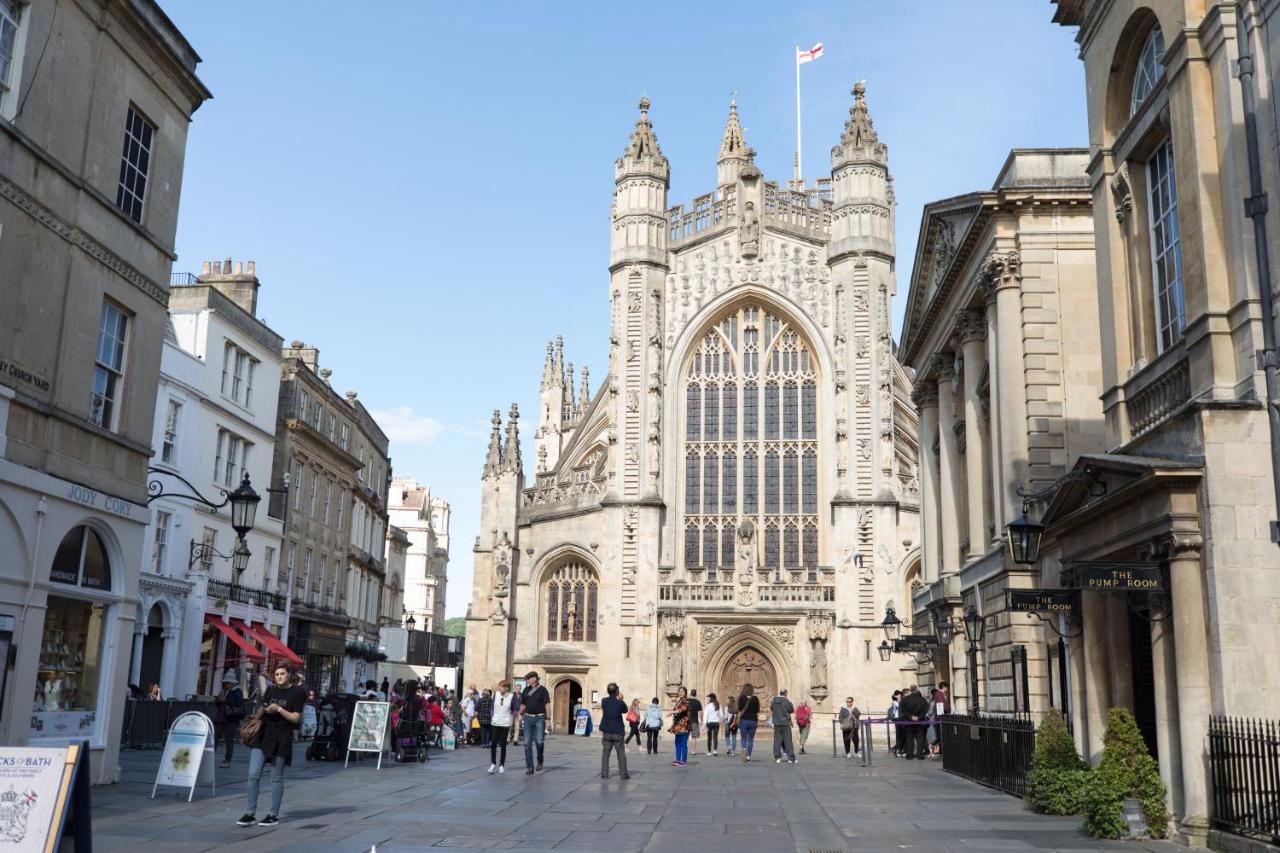 a group of people walking in front of a cathedral at The Black Fox in Bath